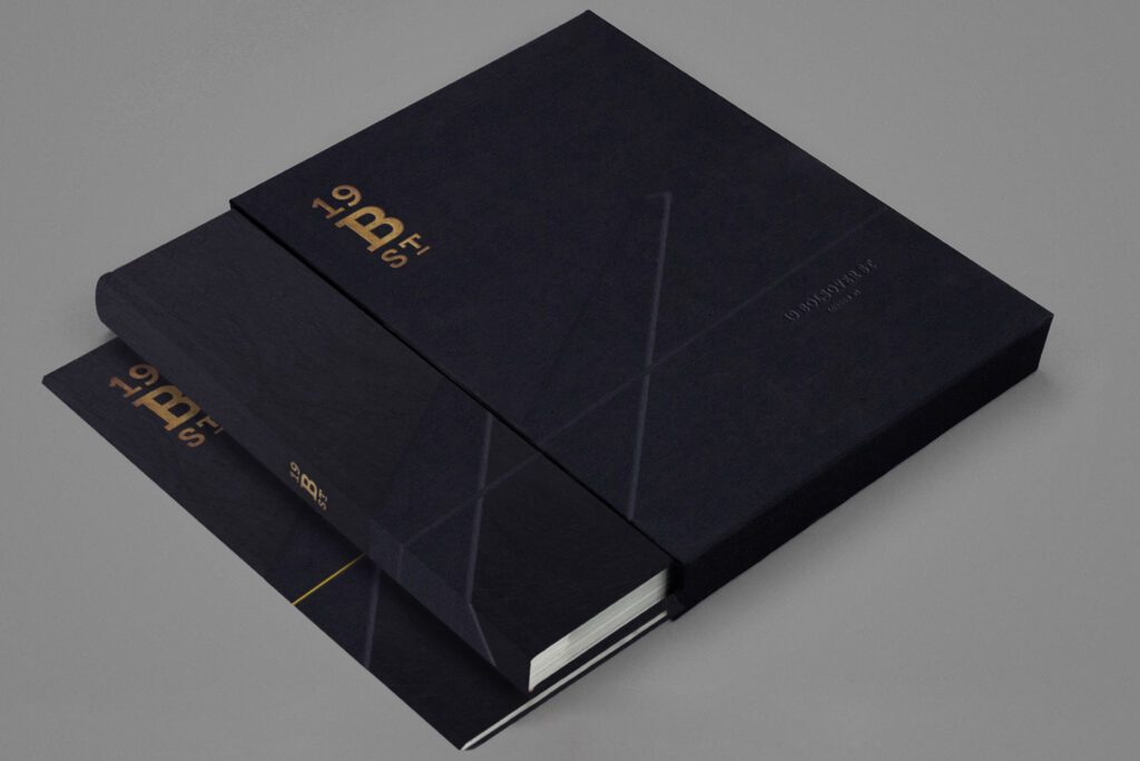 Minimalist black brochure cover with gold embossed lettering reading “19 B ST” and “19 Bolsover St London W1.”
