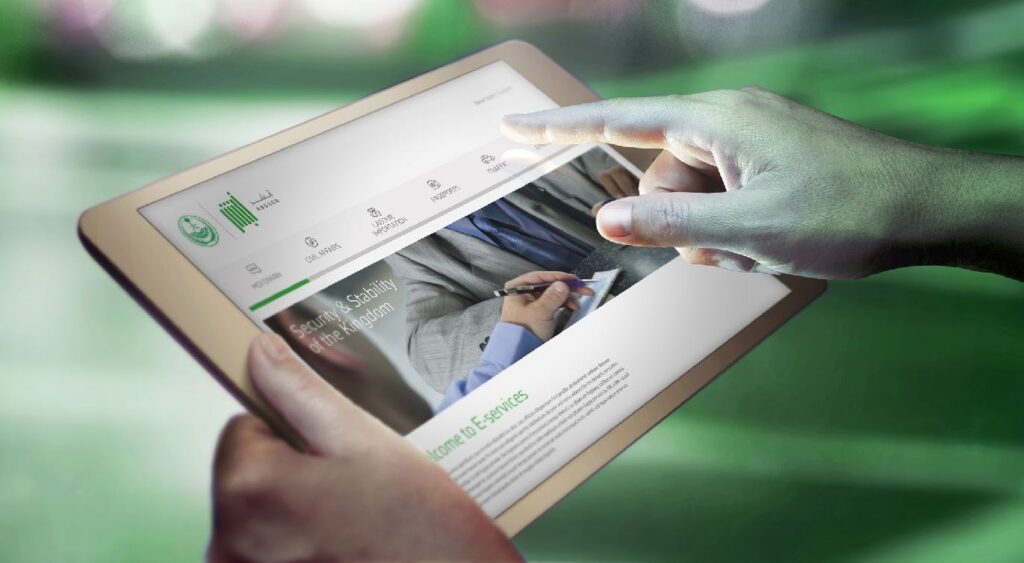 Person using a tablet showing a digital service interface with icons and text, illuminated by a green ambient light.